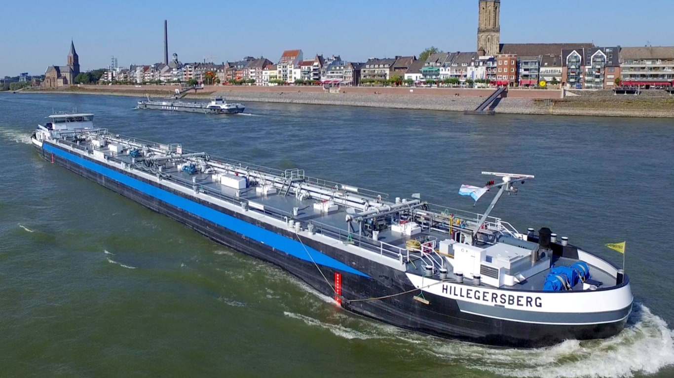 John Deere-powered Hillegersberg vessel passing through a canal.